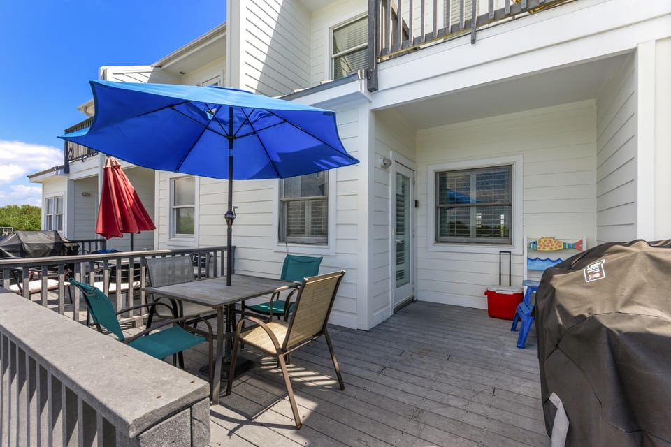 Deck seating and umbrellas outside the townhome