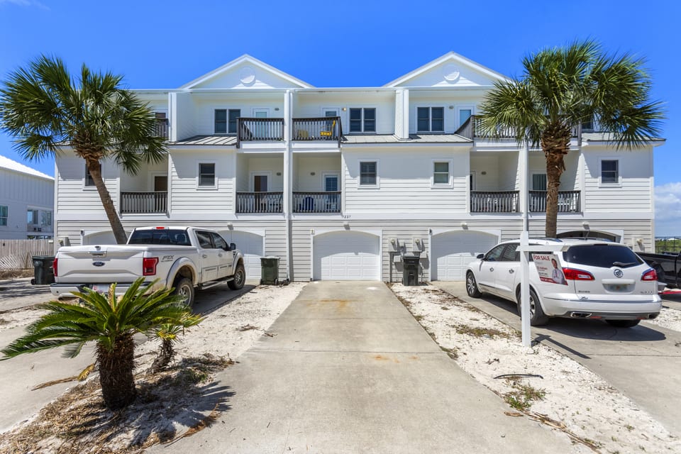 The townhomes from the street, with covered parking beneath