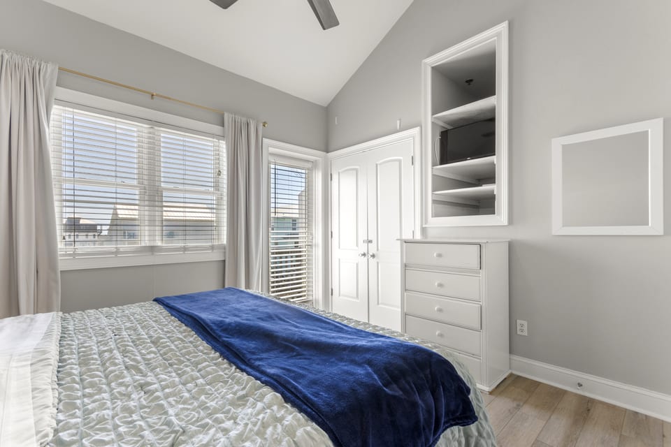 Primary bedroom with built-in storage and window seat